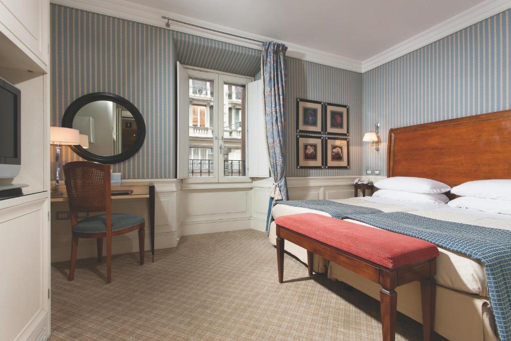 Postel nebo postele na pokoji v ubytování Stendhal Hotel