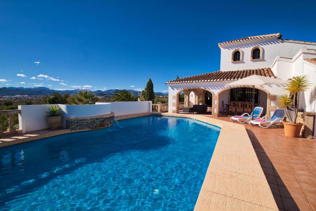 a swimming pool in front of a villa at Los Arcos, Javea in Jesus Pobre