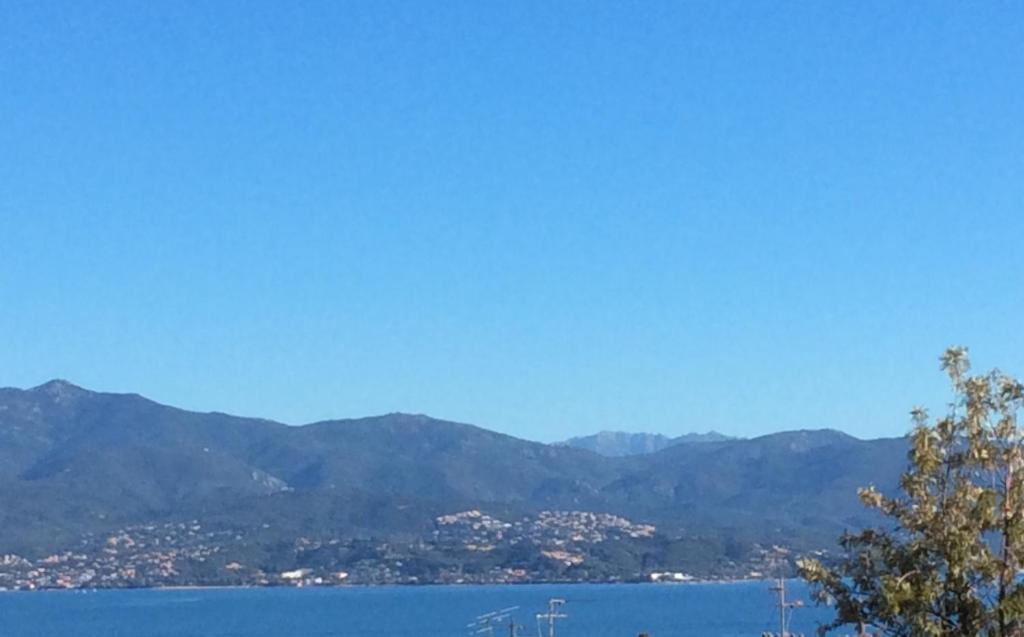 a large body of water with mountains in the background at Le Casone in Ajaccio