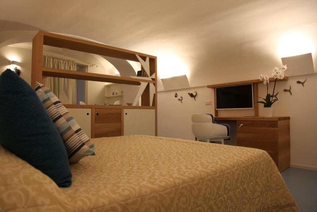 a hotel room with a bed and a television at Arco della Rua in Amalfi