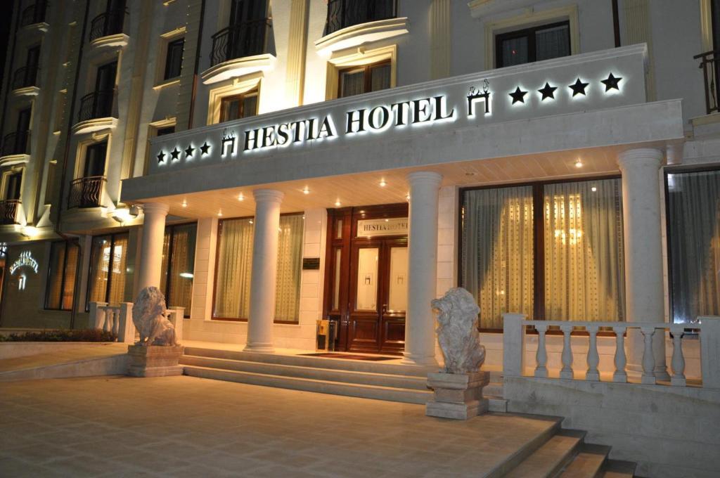 a hotel with a sign on the front of a building at Hestia Hotel in Călăraşi
