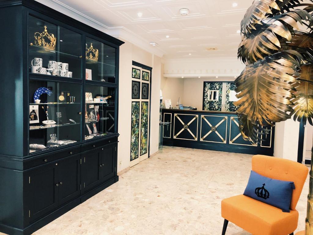 a room with a chair and a display case at Napoleon in Ajaccio