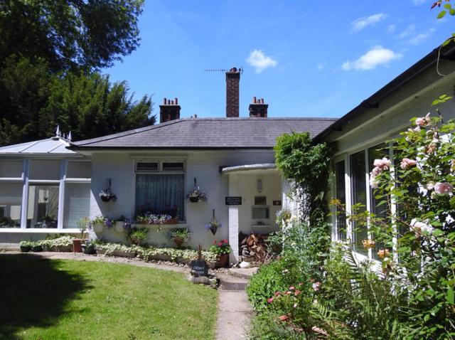 a white house with a garden in front of it at Otters Green in Botley