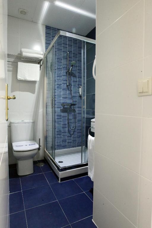 a bathroom with a shower and a toilet at Rincón de Gran Vía in Madrid