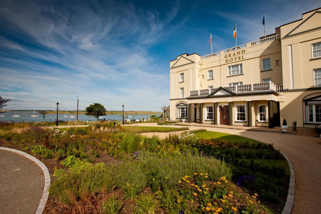 a hotel with a garden in front of a building at Grand Hotel in Malahide