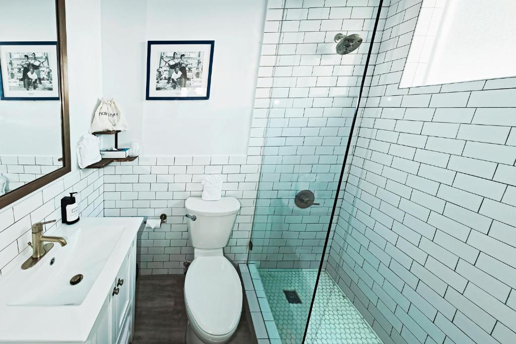 a bathroom with a toilet and a sink and a shower at Sunset Inn in Islamorada