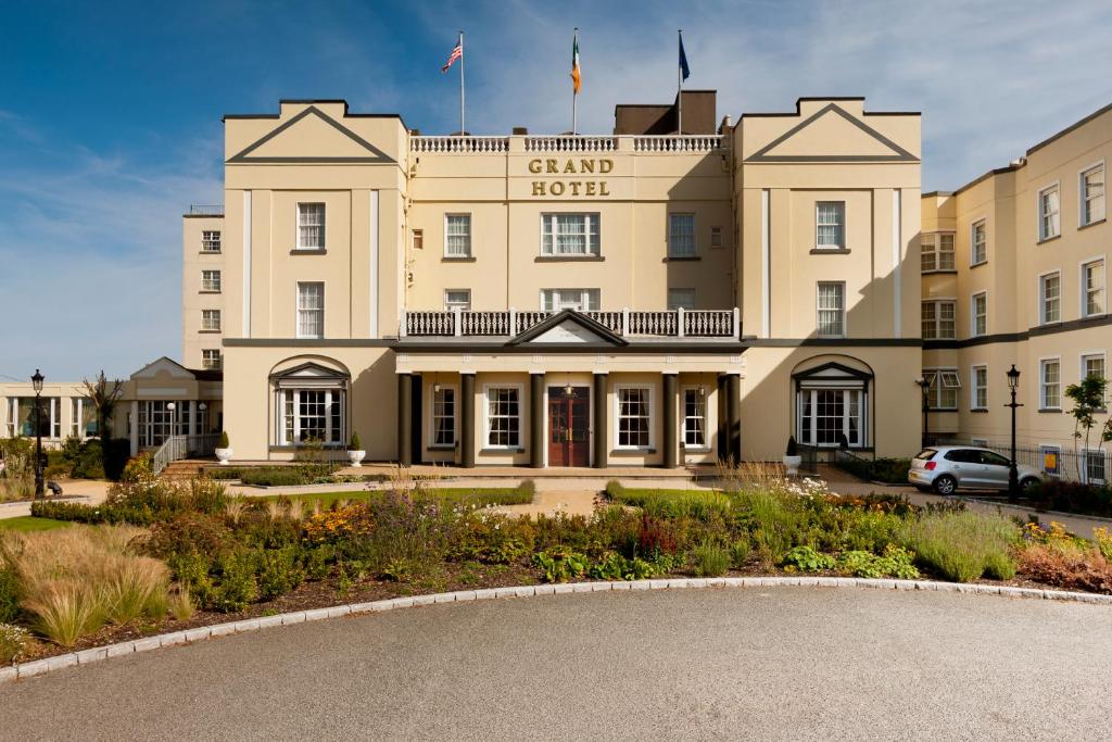 a large building with a flag on top of it at Grand Hotel in Malahide