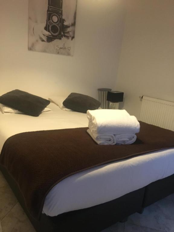 a bedroom with two beds with black and white pillows at Studio Grand Rue in Colmar