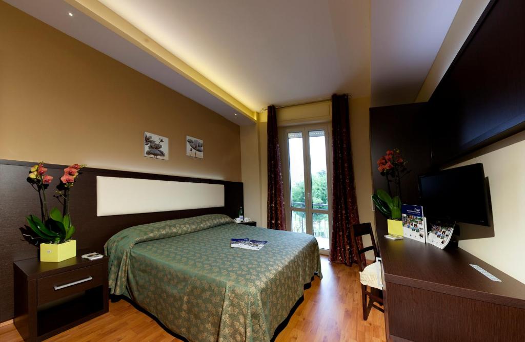 Postel nebo postele na pokoji v ubytování Hotel Verdi
