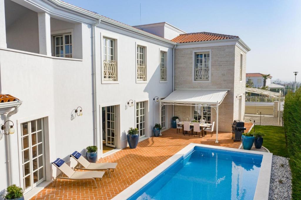 an exterior view of a house with a swimming pool at Villa Fiordaliso in Vabriga