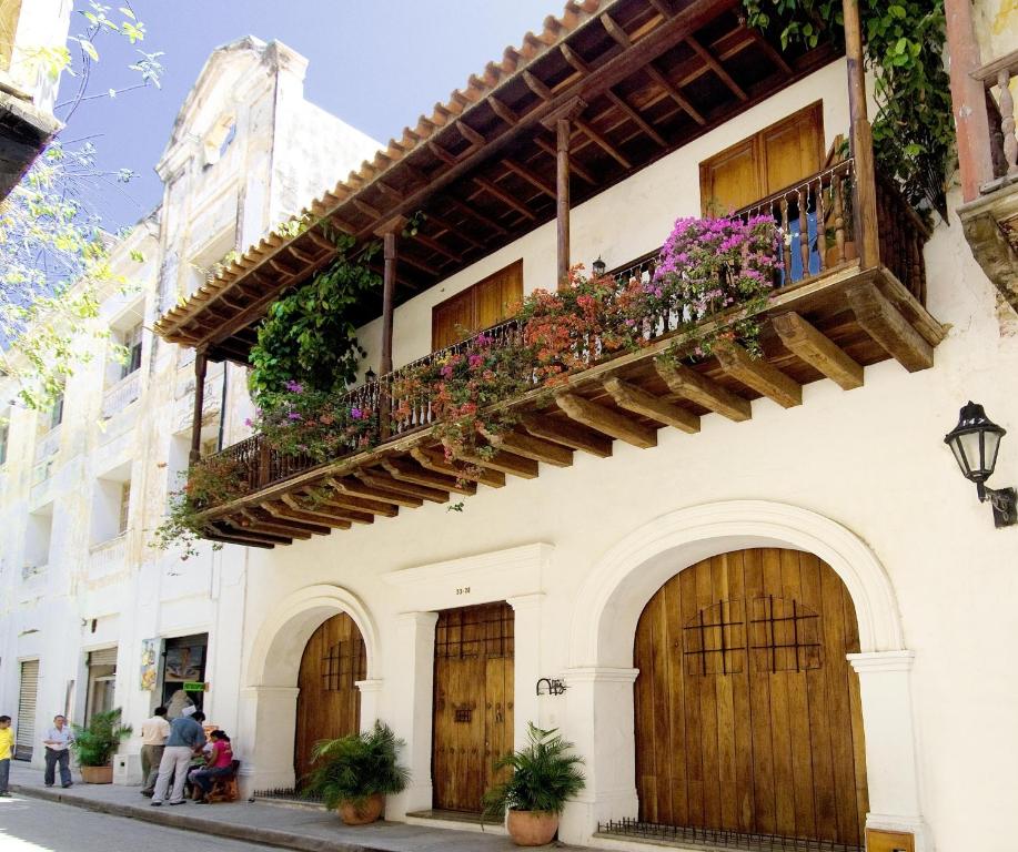 a building with a balcony with flowers on it at Alfiz Hotel in Cartagena de Indias