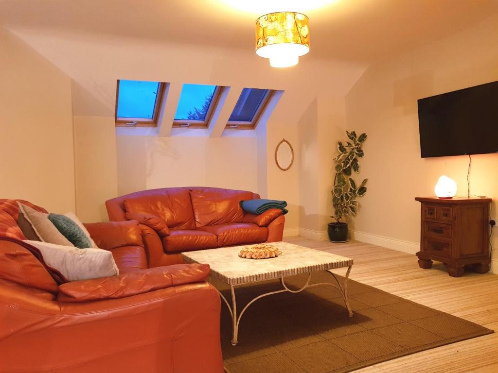 a living room with a couch and a coffee table at Ethan House Holiday Suites in Killarney