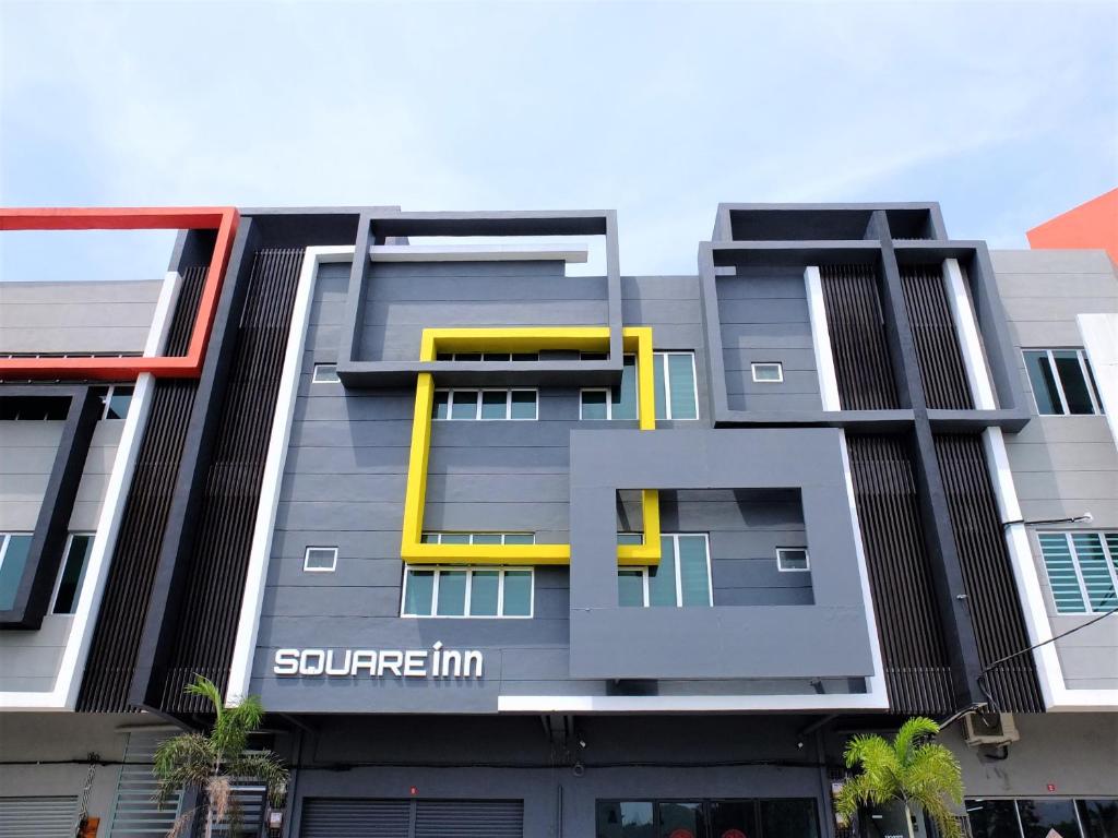 a tall building with yellow and gray at SQUARE Inn in Taiping