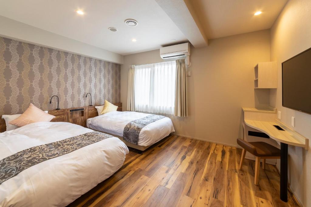 Postel nebo postele na pokoji v ubytování SARASA HOTEL Dotonbori