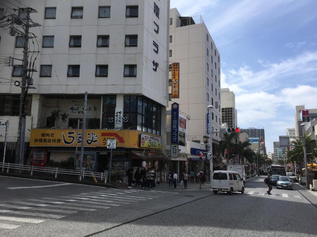 a busy city street with a white van on the street at Hotel Kokusai Plaza (Kokusai-Dori) in Naha