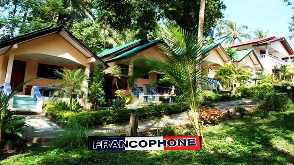 a house with a sign in front of it at Anawin Bungalows in Ao Nang Beach