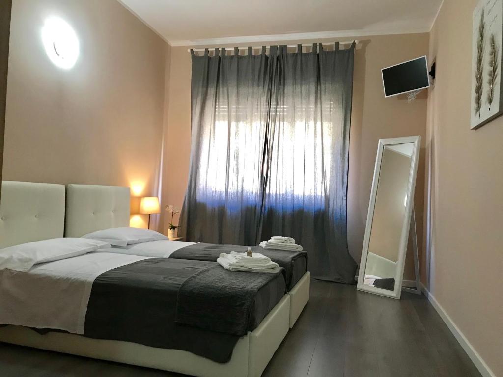 Postel nebo postele na pokoji v ubytování L'Arena Residence