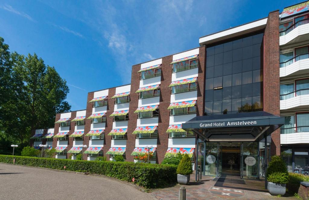 a large brick building with a building at Grand Hotel Amstelveen in Amstelveen