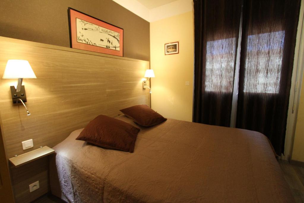 Postel nebo postele na pokoji v ubytování Le Provençal