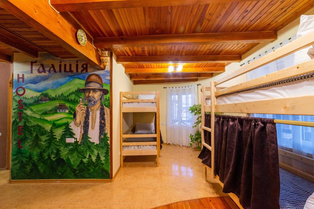 a room with bunk beds and a mural of a cowboy at хостел Галіція in Kolomiya