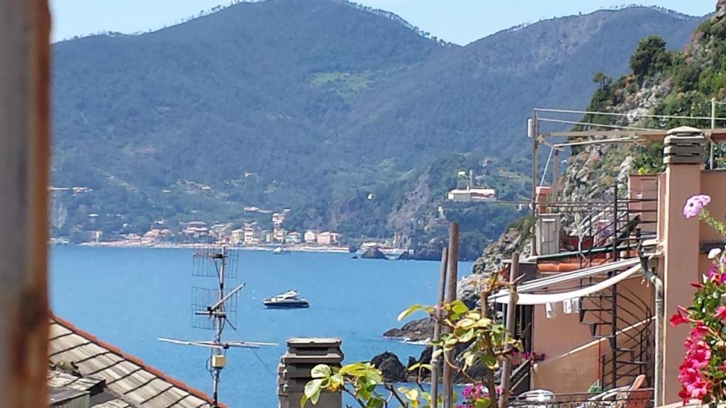 a view of a body of water with mountains at Rina Rooms in Vernazza