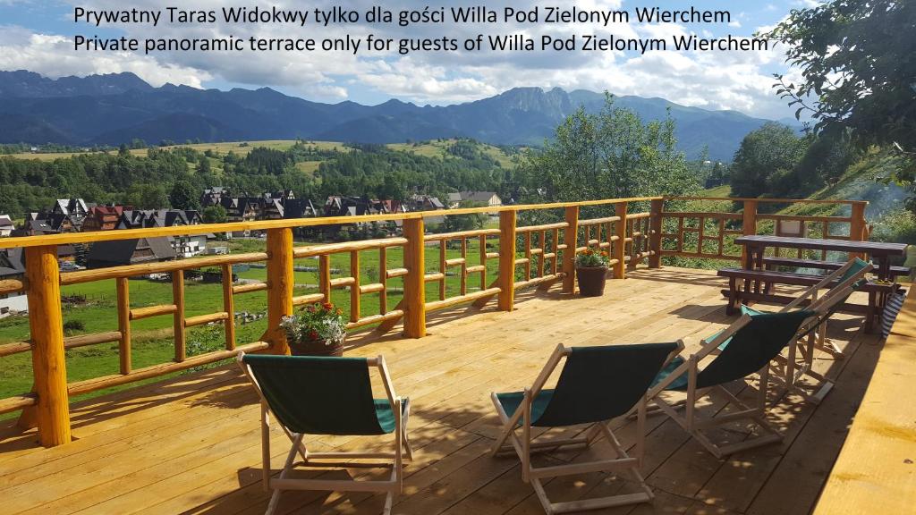 a deck with chairs and a view of a mountain at Willa Pod Zielonym Wierchem in Zakopane