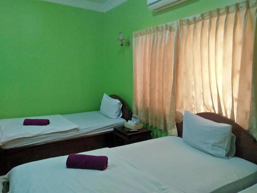 Postel nebo postele na pokoji v ubytování Sam So Guesthouse