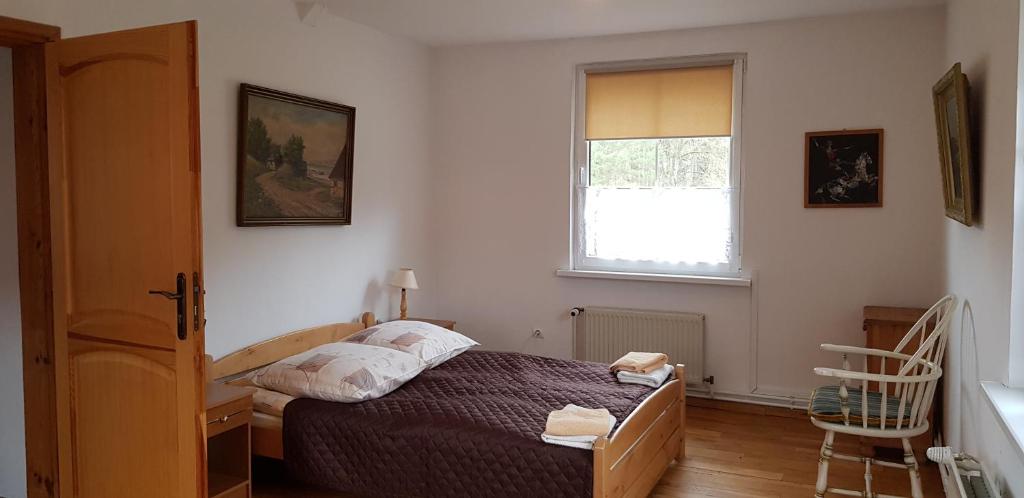 Posteľ alebo postele v izbe v ubytovaní Apartamenty Drewniany Dom