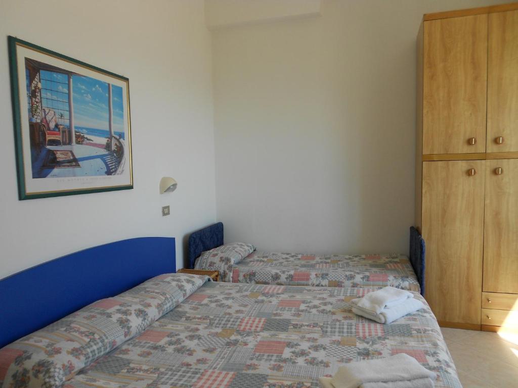 Postel nebo postele na pokoji v ubytování Hotel Laguna Blu