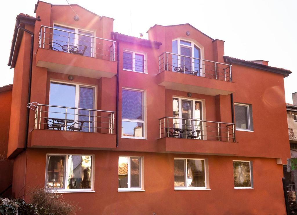 an orange building with balconies on the side of it at New Star Residence in Burgas City