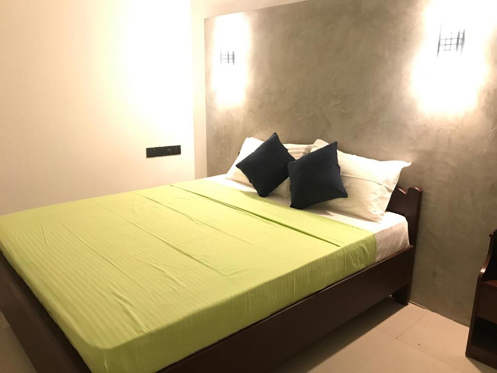 A bed or beds in a room at Kingdom Gate Hotel