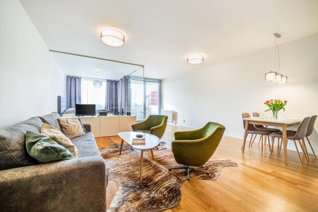 a living room with a couch and a table at Mill Apartments in Brno