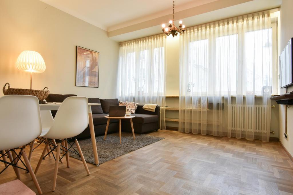 a living room filled with furniture and a window at Smulikowskiego 9 in Warsaw