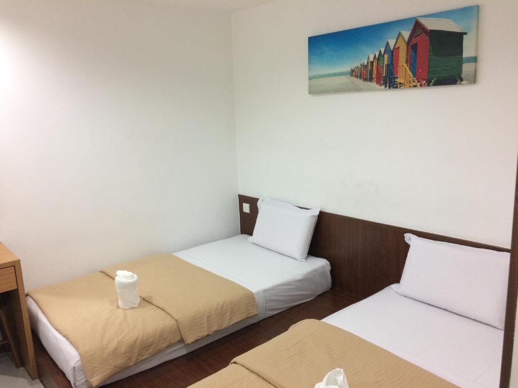 Voodi või voodid majutusasutuse Api-Api GuestHouse toas
