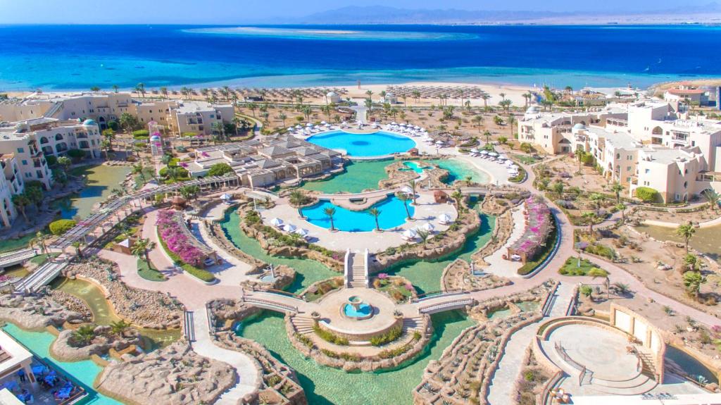 an aerial view of a resort with a pool and the ocean at Kempinski Hotel Soma Bay in Hurghada
