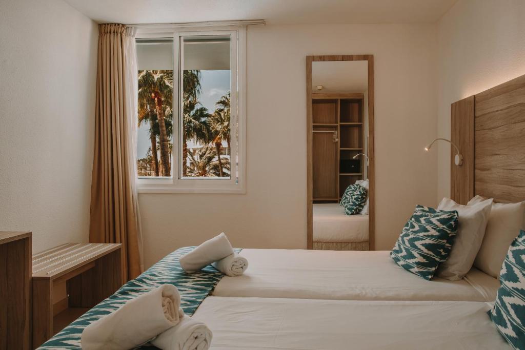 A bed or beds in a room at Playa Del Sol - Adults Only