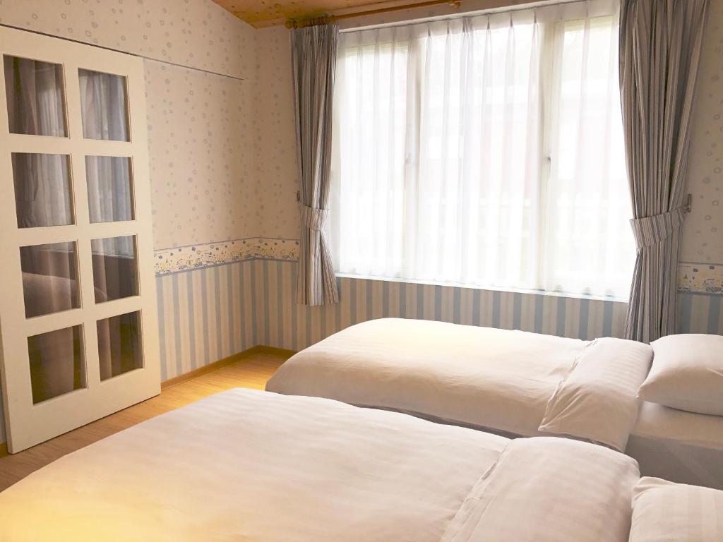 Postel nebo postele na pokoji v ubytování American Village Resort