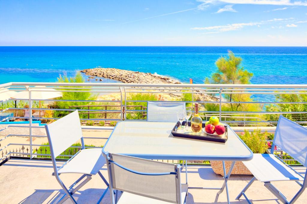 un tavolo con vassoio di frutta su un balcone con vista sull'oceano di Villa Lucrezia - San Lorenzo al Mare a San Lorenzo al Mare