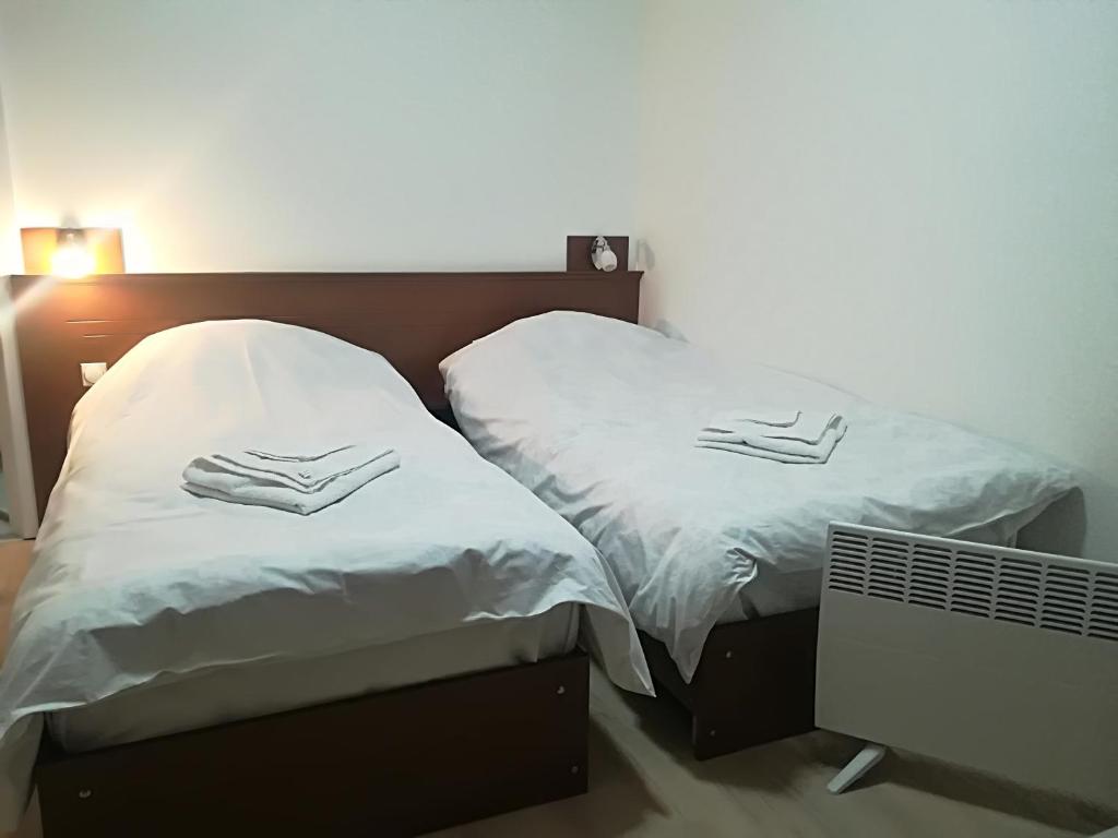 two beds sitting next to each other in a room at KIKO Krusevo in Kruševo