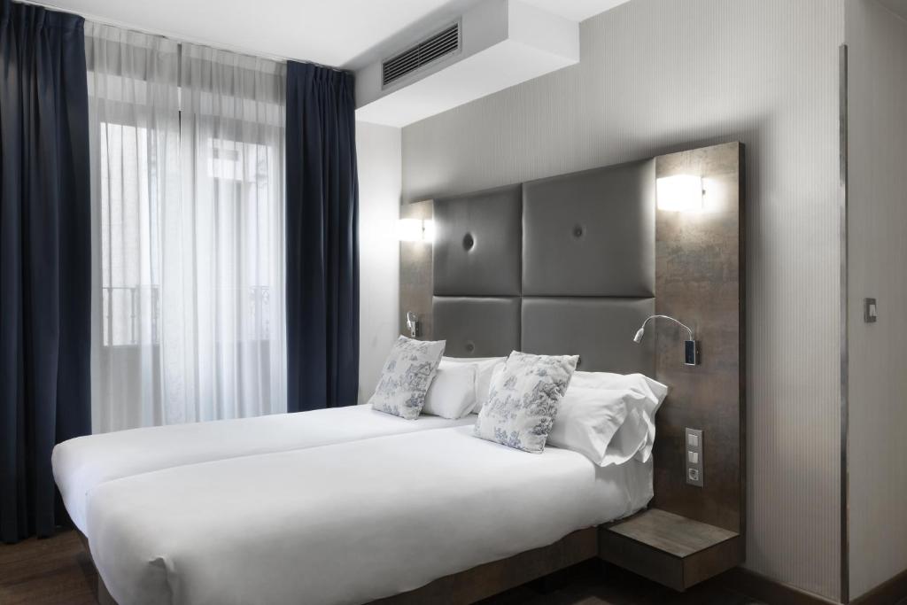 A bed or beds in a room at Petit Palace Posada del Peine