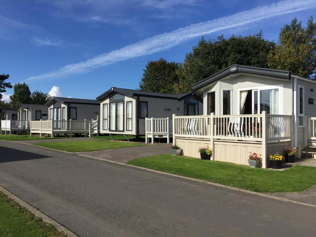 a row of mobile homes on the side of a road at Royal Oak Caravan Park in Skegness