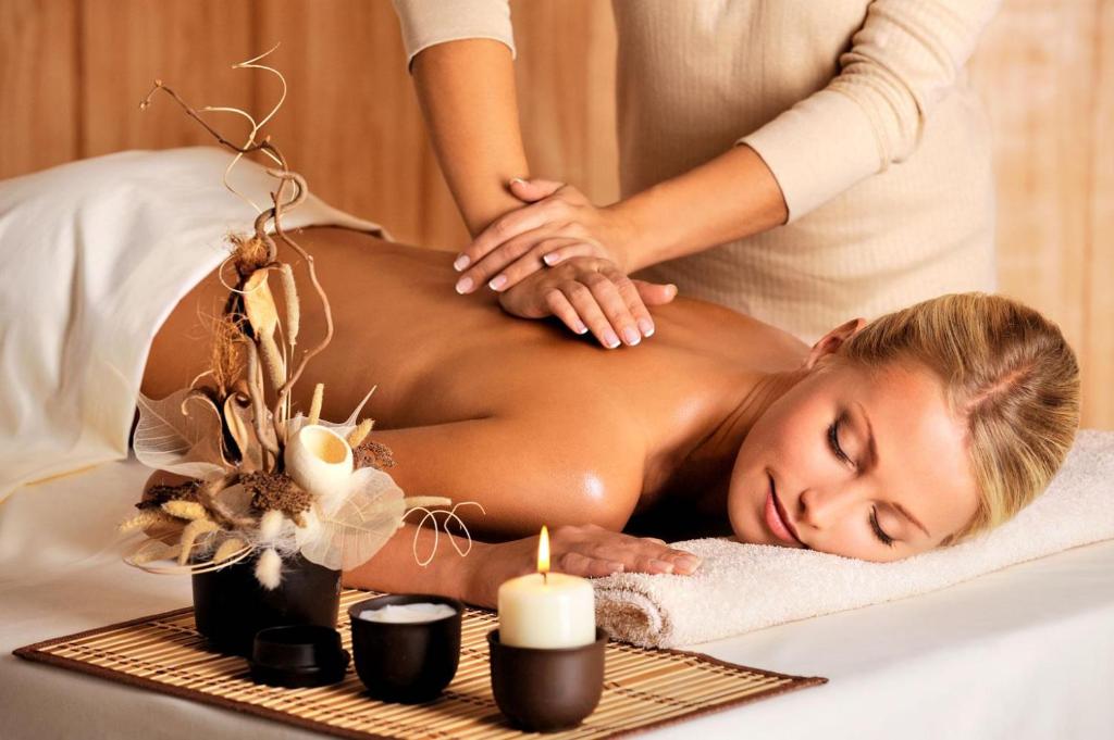 a woman getting a massage in a spa at Atlantide in Muravera