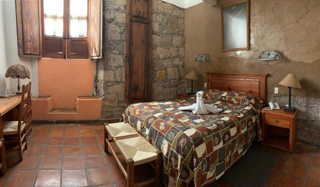 Postel nebo postele na pokoji v ubytování Hotel Casa del Anticuario