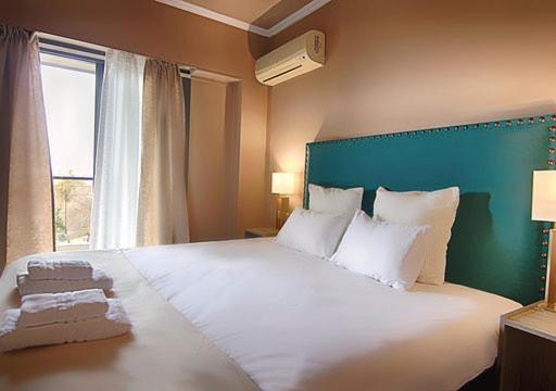 Postel nebo postele na pokoji v ubytování Galaxy Hotel