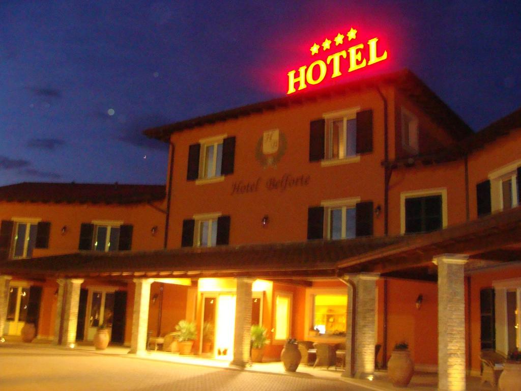 a hotel with a neon sign on top of it at Hotel Belforte in Ovada