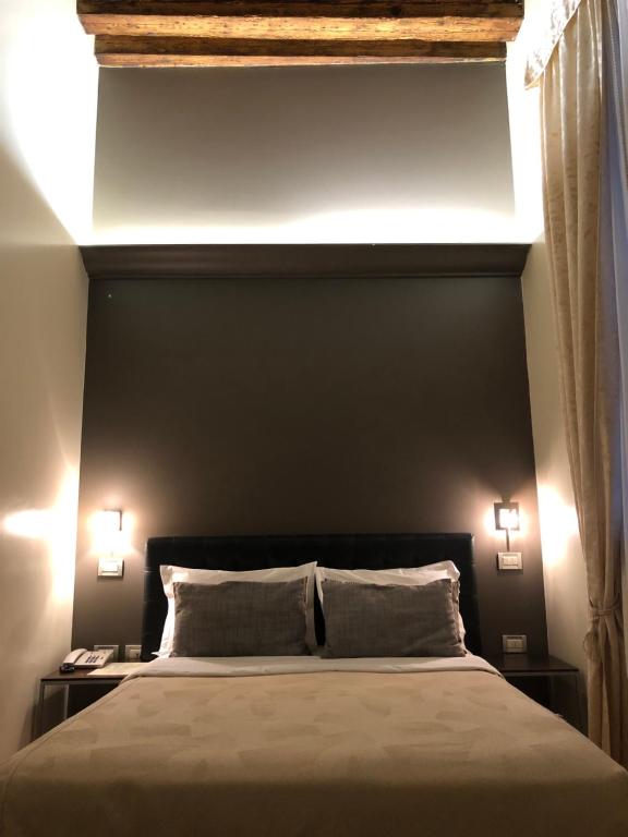 Postel nebo postele na pokoji v ubytování Albergo al Tiepolo