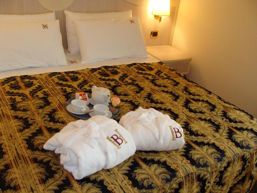 Postel nebo postele na pokoji v ubytování Hotel Belforte