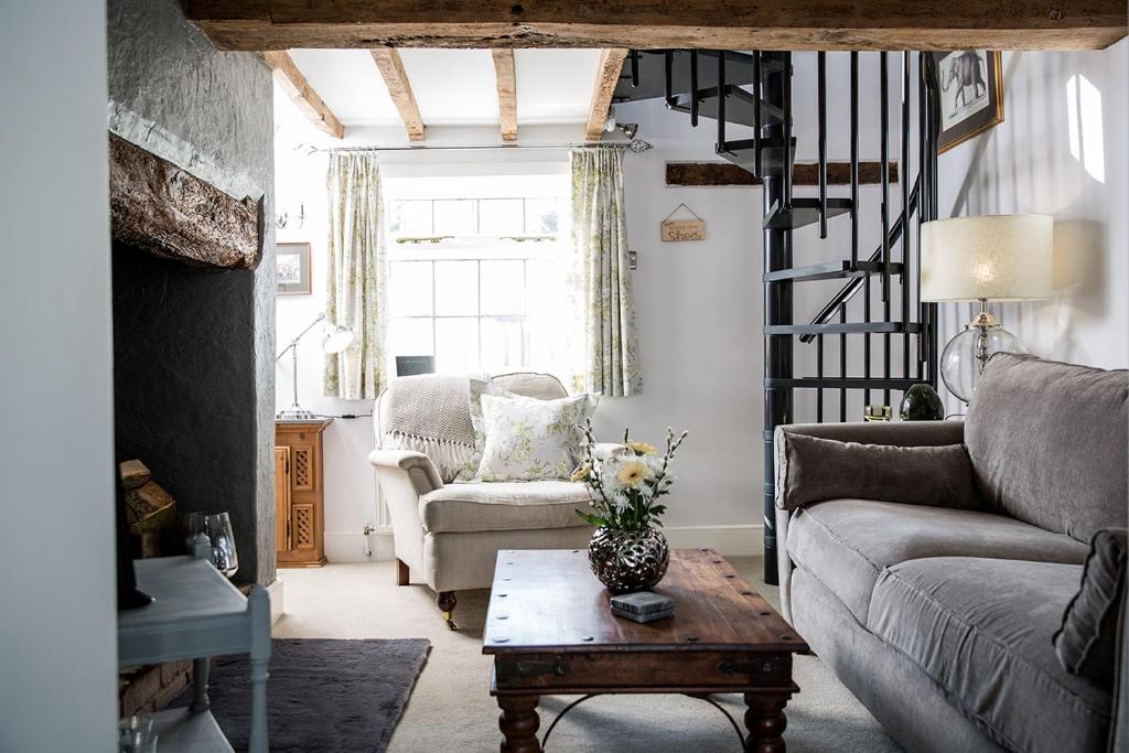 a living room with a couch and a table at The Nook, Gretton (Cotswolds) in Gretton