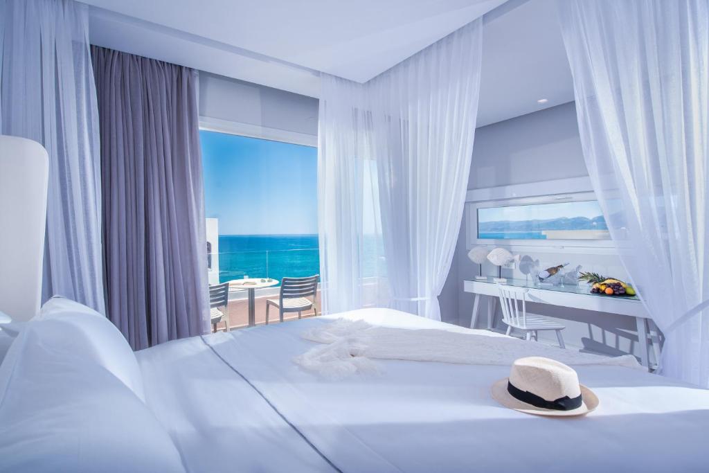 a hotel room with a bed with a hat on it at Mari Kristin Beach Hotel in Hersonissos