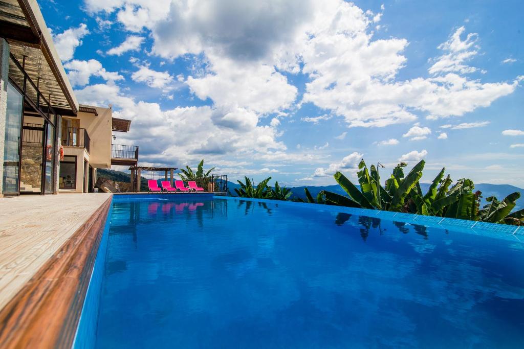 a large blue swimming pool with a view of the mountains at Hotel Casa Portones in San Bernardo